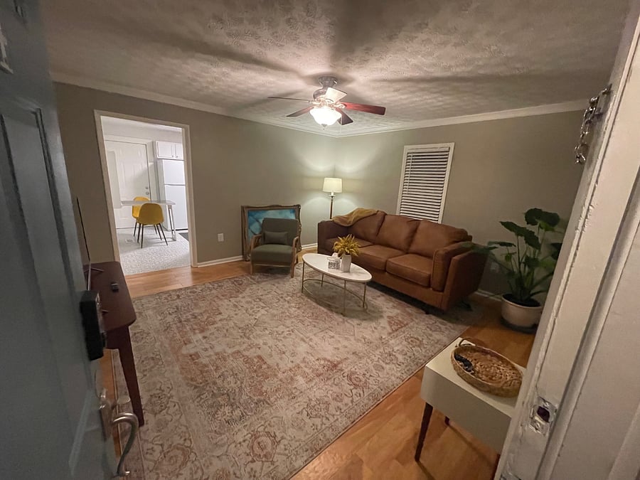 Spacious living room with leather sofa and 55" 4K LED smart tv.