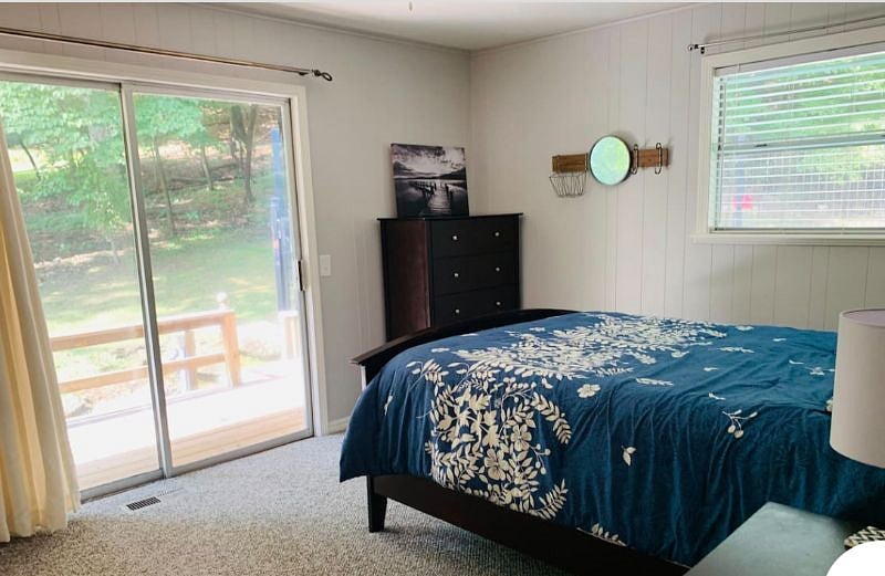 Queen bedroom upstairs. This has a sliding glass door leading to the backyard. This bedroom has a private master bathroom