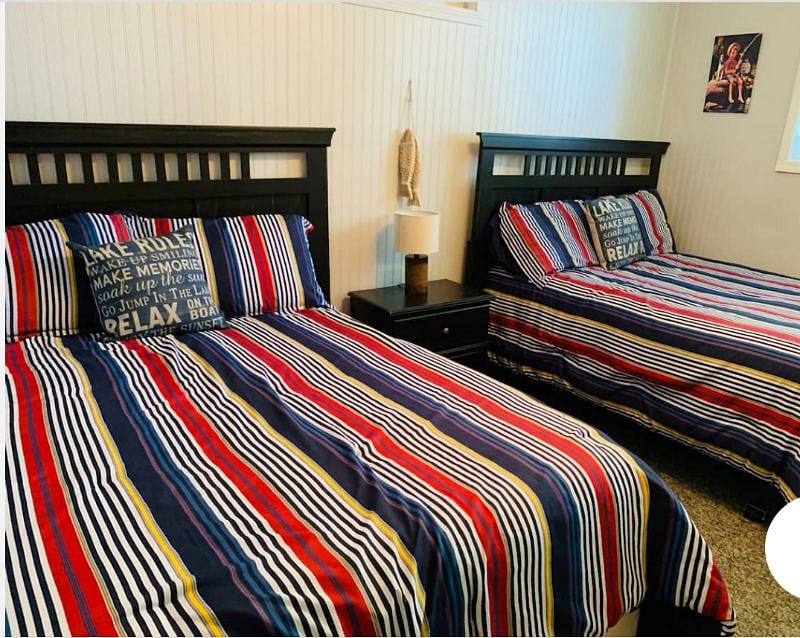 This bedroom has 2 double beds and 1 closet. No dresser but does include night stand with 2 drawers.