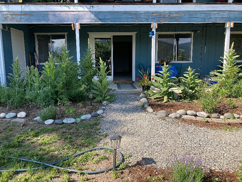 Outdoor entrance with a private patio and flower gardens