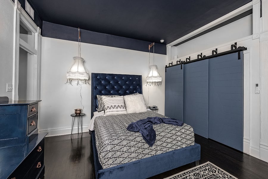 Bedroom w/ Queen bed and sitting area, large closet with triple bypass barn style doors