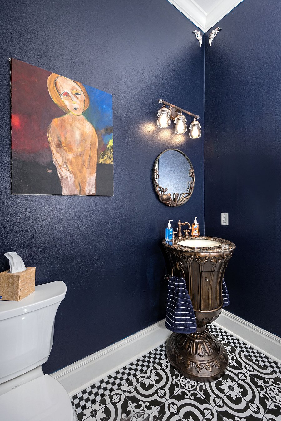 Luxurious bathroom with restored clawfoot tub, copper fixtures, and Moroccan Mosaic tile shower wall w/ rain can shower head and separate tub faucet and handheld wand.
