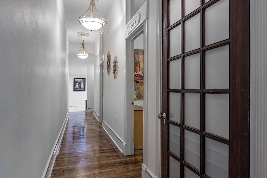 Hallway perspective (Laundy closet, 1st bedroom w/ queen bed, 2nd bedroom with full bed, kitchen and bath in back)