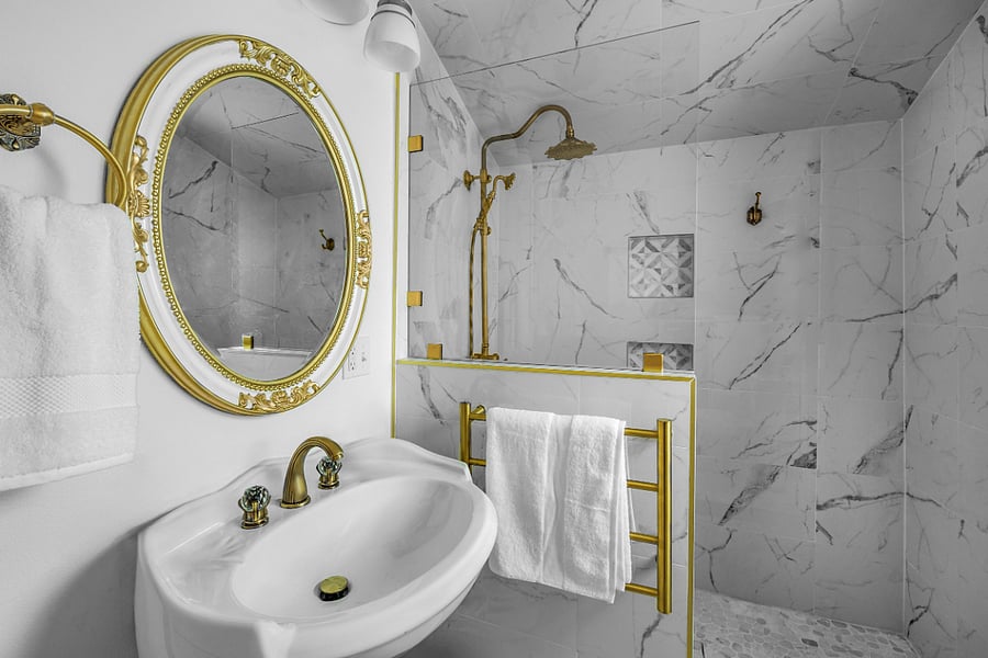 Marble bathroom with walk-in shower, rain can shower head, swinging glass door (nearly 180 swing: 90 inward and outward), antique brass fixtures