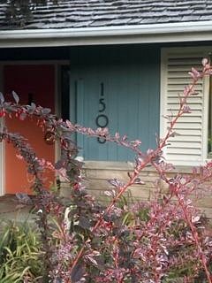 Front of house with main entry door.