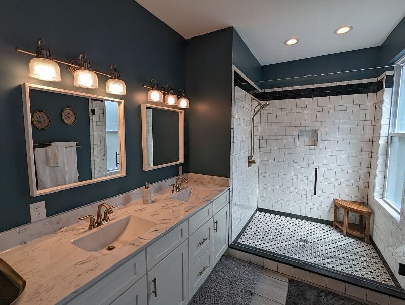 Luxurious primary bathroom with double sinks and spacious shower.