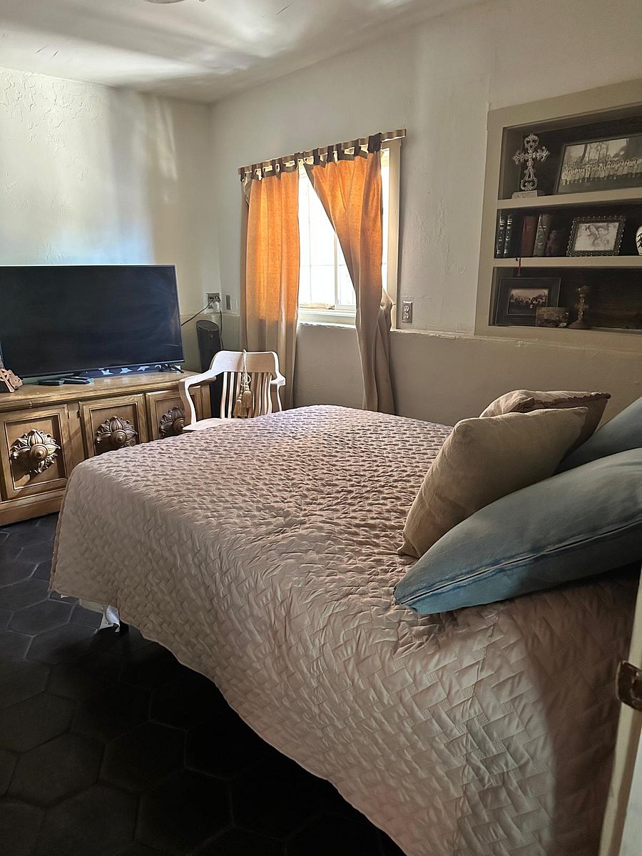 Second bedroom is complete with a large TV.