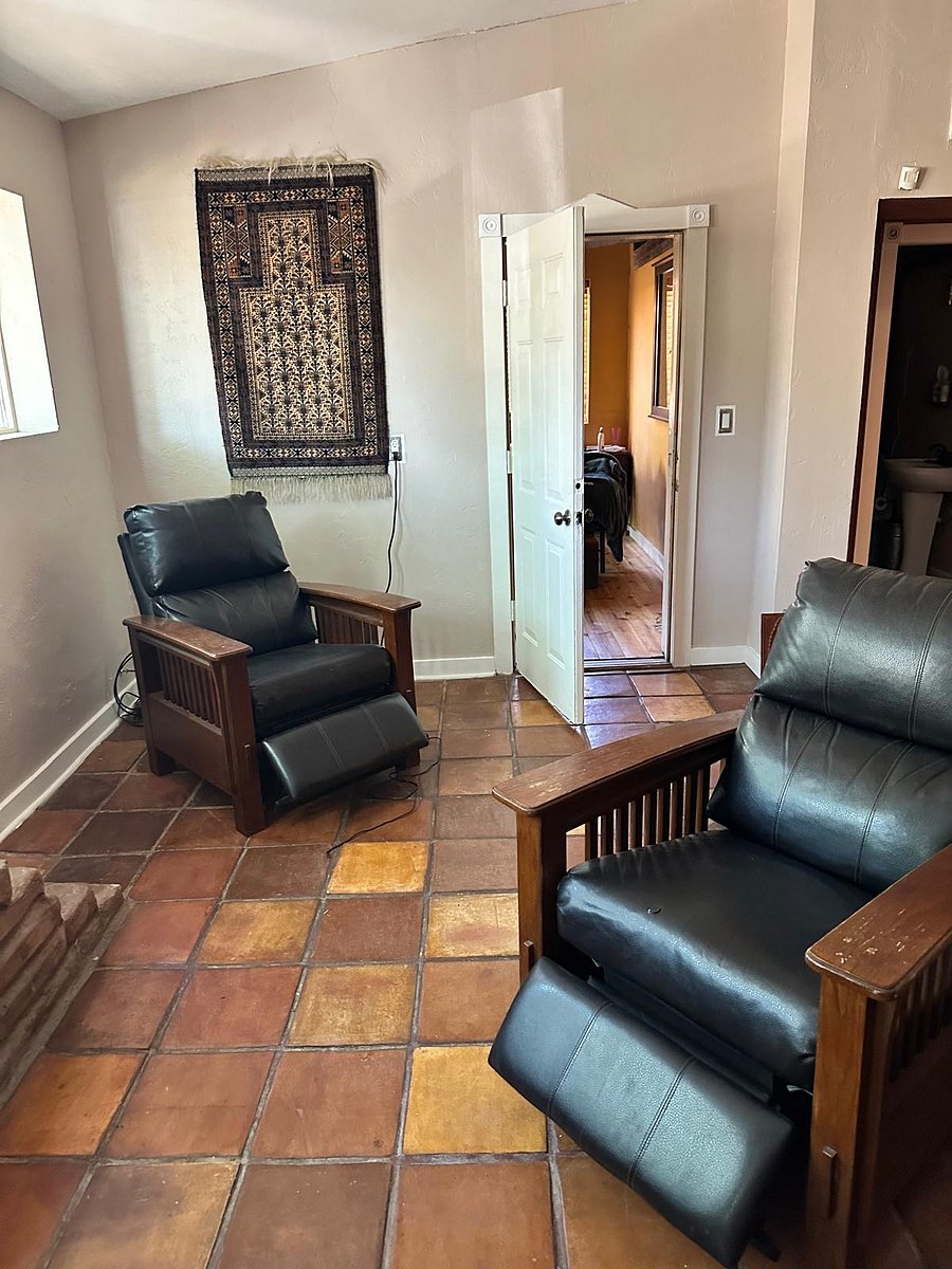 Additional seating in the Living Room with an open door headed to the first bedroom.