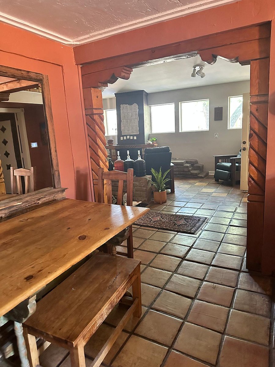 Looking from the Dining Area into the Living Room. The first bedroom is off to the far right, and the second bedroom is down the left hallway. 