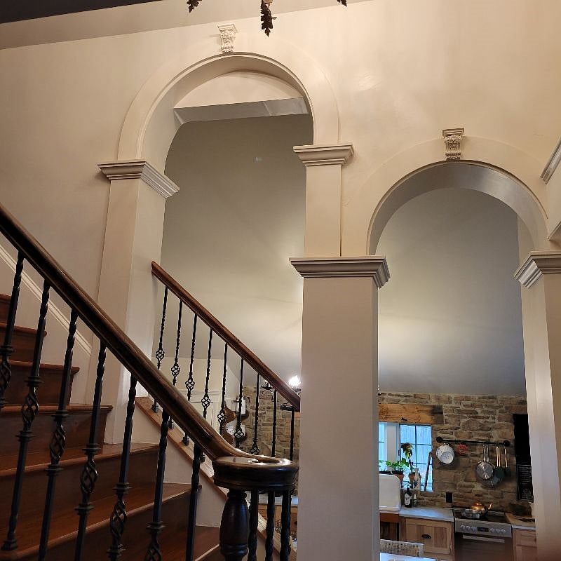 Tall arches connect the kitchen and living room, but allows a view of both rooms.