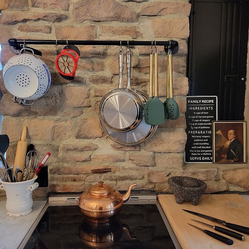 Stone back splash behind the stove, includes white marble counter tops.