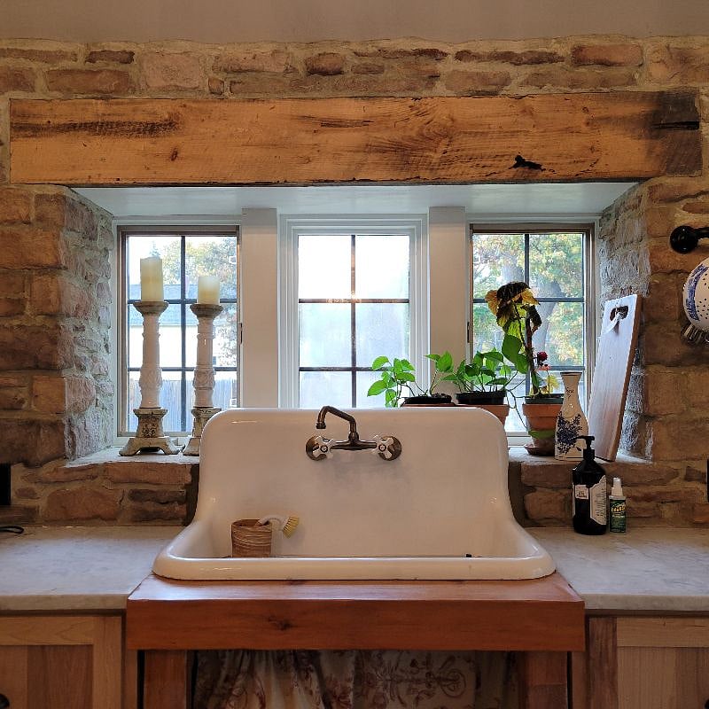 Kitchen sink cast iron, white marble counter tops, with view of the back yard, very private and enclosed yard.