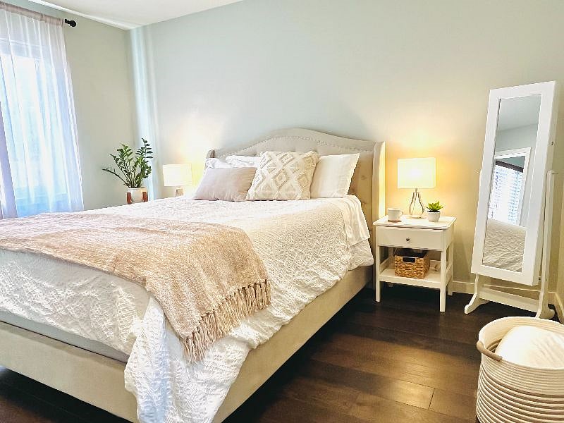 Master bedroom with a 60" TV, walk-in closet, and en suite