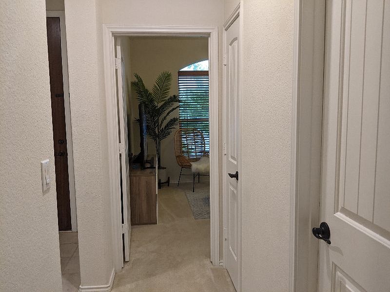 View to living room from the bedroom. The two doors on the right sides are the bathroom and the storage.