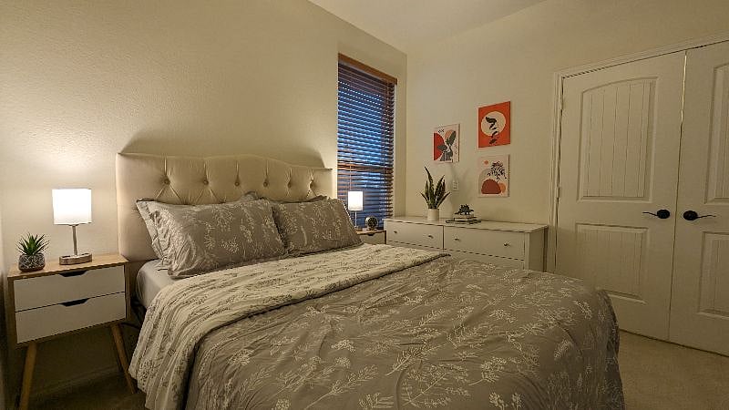 Comfy Queen bed fully furnished with sheets and linens.