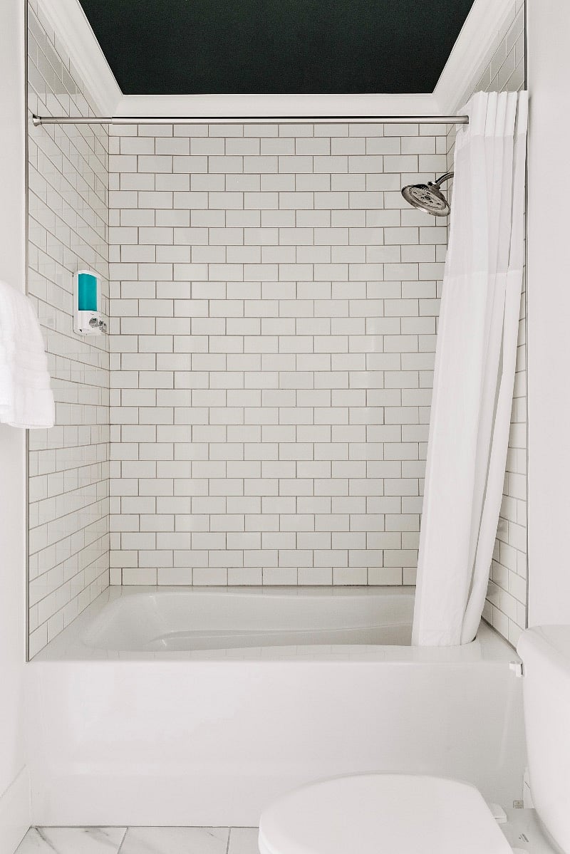 Bathroom 2 with subway tiled tub/shower, fluffy towels, and plenty of space. 