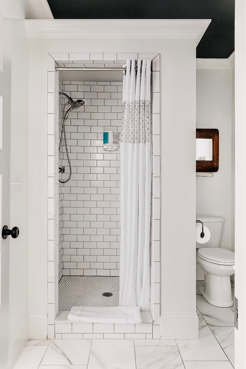Immaculately clean bathroom 1 with subway tile shower.