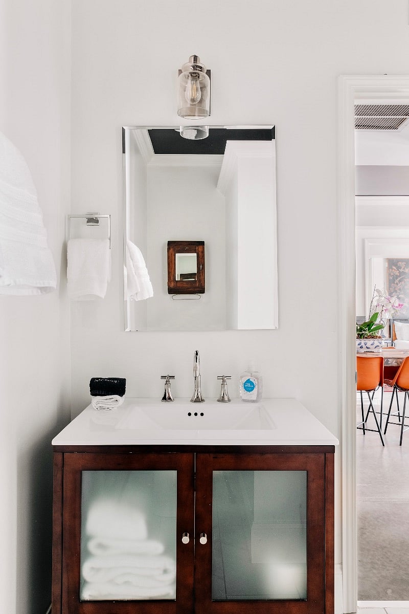 Bathroom 1 with common area access and a hair dryer under the sink. 