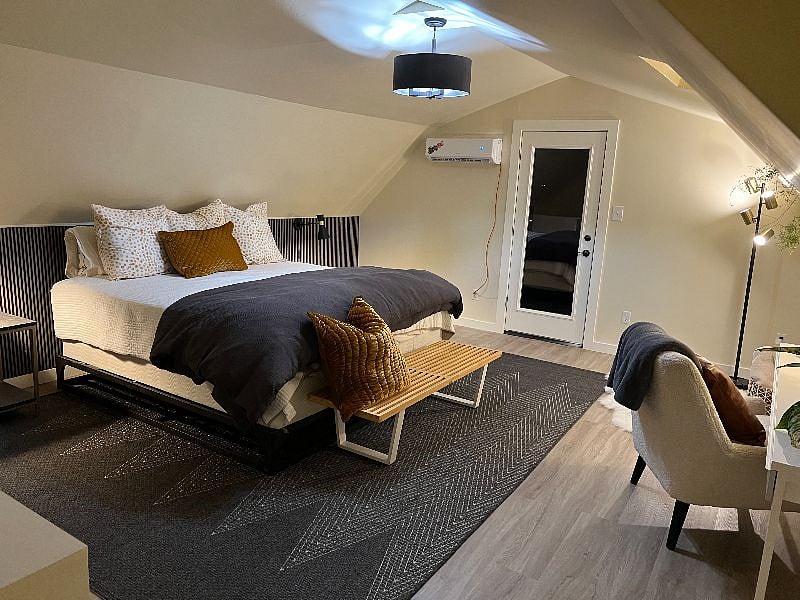 King size bed with lighting and night stands for each side of the bed.