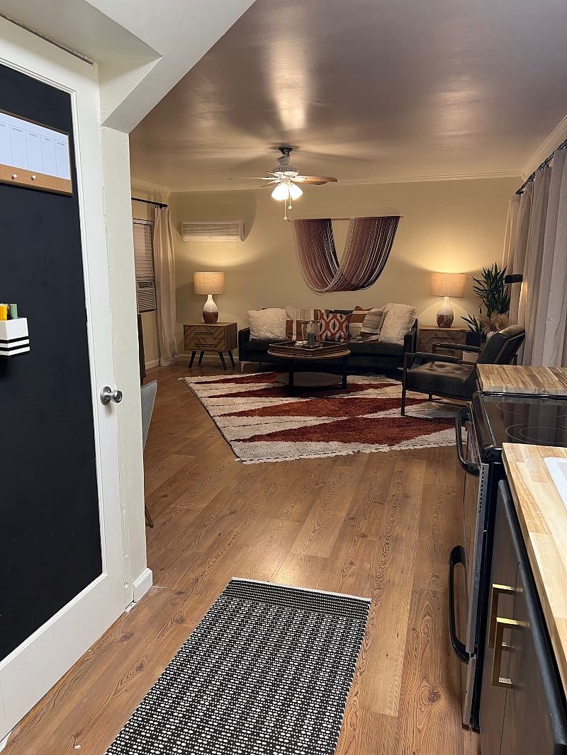All hardwood services (including stairs) living room has an area rug as does the bedroom.