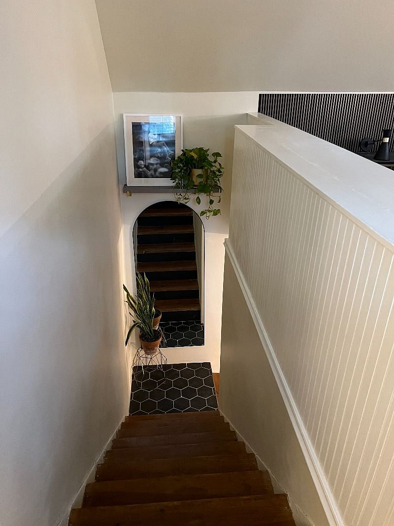 Tiled and wooden stairs lead to the open loft large bedroom, study and walk in closet.