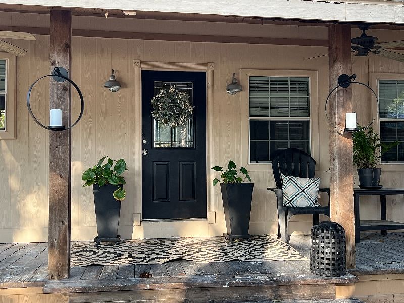 Porch offers place to relax with chairs and a large sectional couch.