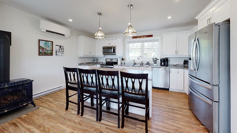 Open kitchen with thermostatically controlled. LP gas woodstove.