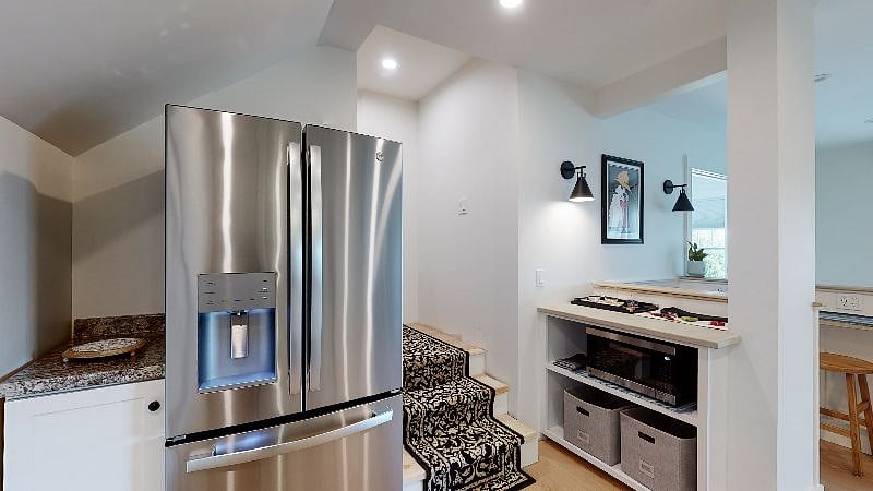 Full-size refrigerator on the lower level for overflow