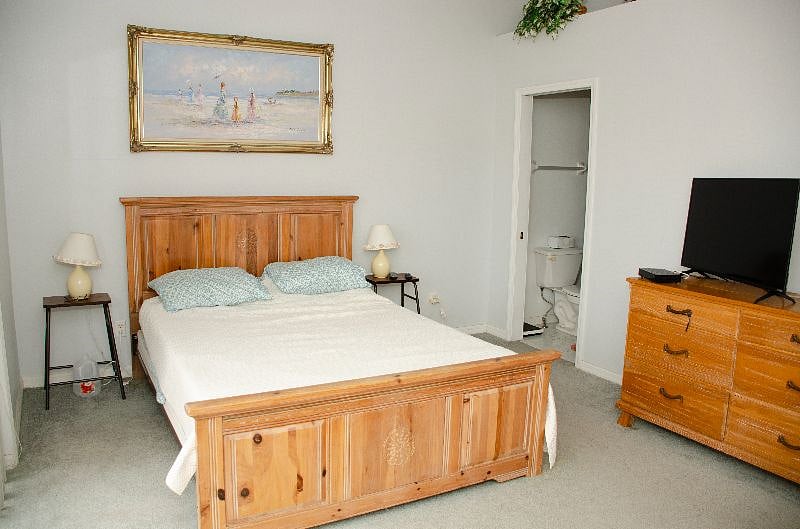 Master Bedroom w Queen Bed, bathroom w shower, walk-in closet and Balcony overlooking the Sunderland Bayou.