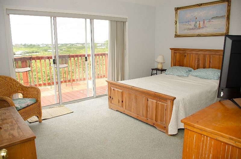 Master Bedroom w Queen Bed, bathroom w shower, walk-in closet and Balcony overlooking the Sunderland Bayou.