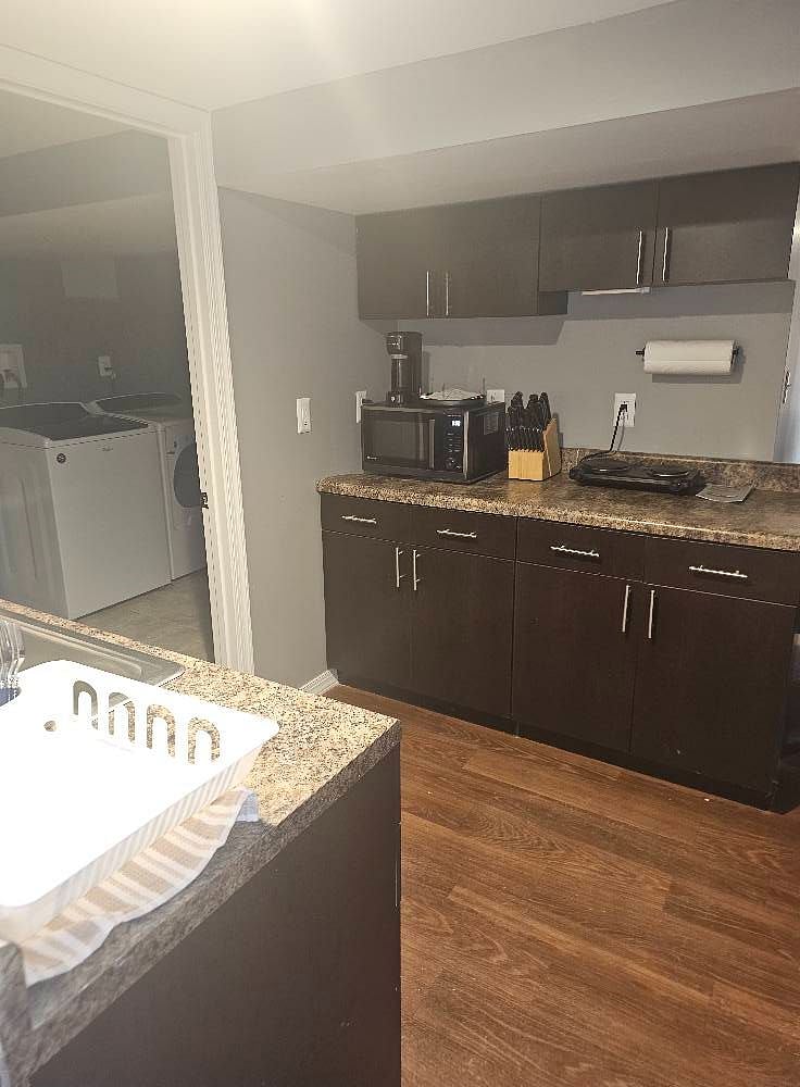 Kitchenette features 2 burners and a Microwave/Convection oven/Air fryer combo.  Perfect for a 10lb Turkey or chicken!  Equipped with slow cooker, coffee maker, plates, cups, flatware, frying pan and small pot.  