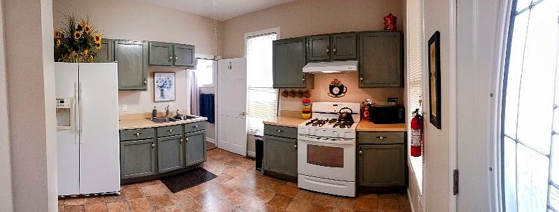 Kitchen includes side by side refrigerator/freezer/ice, gas stove, microwave oven, ceiling fan, and much more. Sole access to the bathroom is through the kitchen