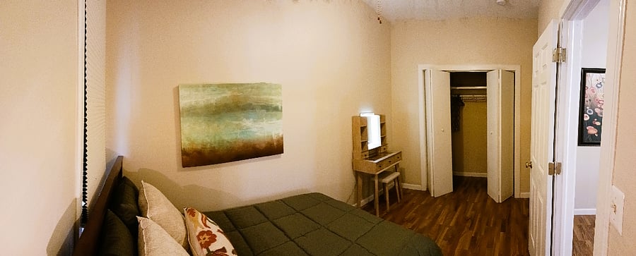 Back bedroom with vanity and closet, including shelving and dresser with two deep drawers