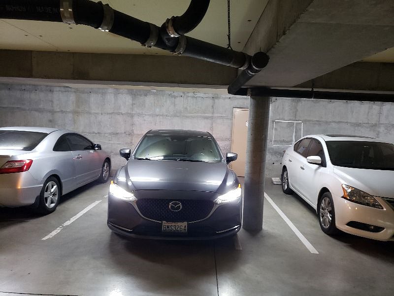 secure garage parking. The garage is secure from both the entry to the garage and then the main gate key is needed to enter the building through that door. The parking spot is right by the door (where gray Mazda is parked)