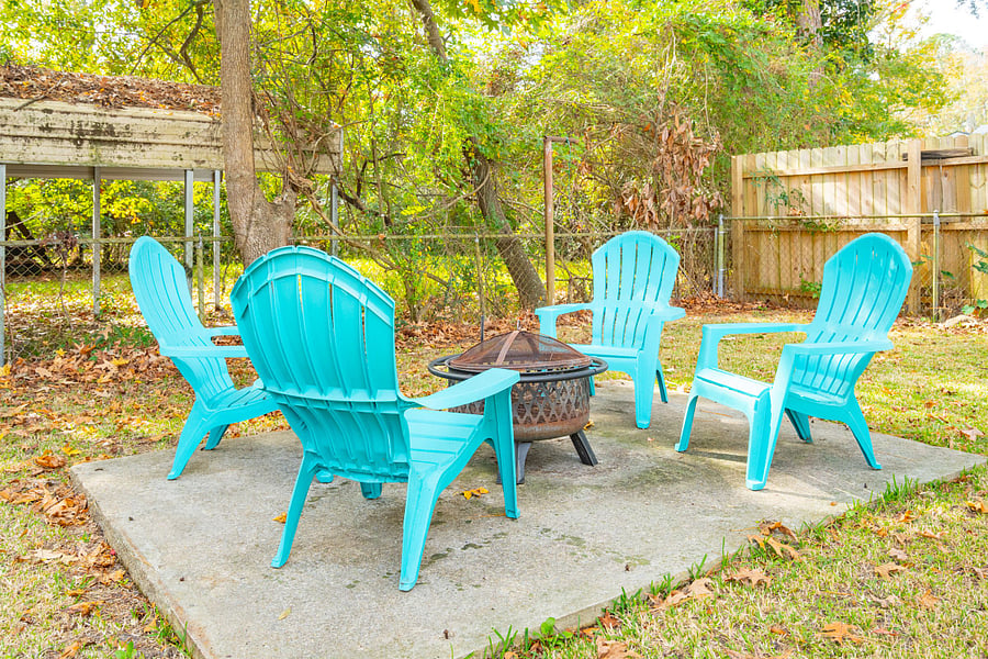 The fully fenced backyard features a cozy fire pit, perfect for unwinding in the evenings. 
