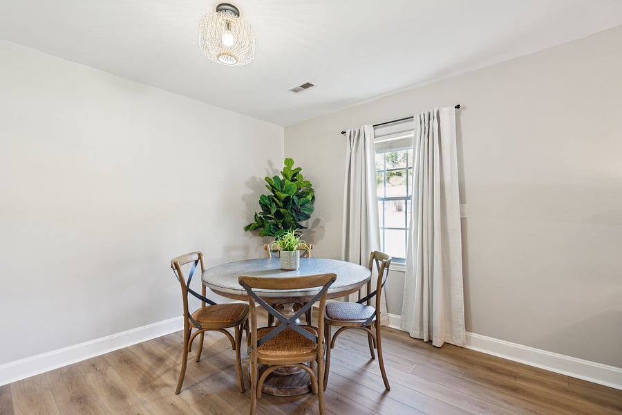 Adjacent to the kitchen is a dining area with a 4-person table and a dedicated workspace for remote work.