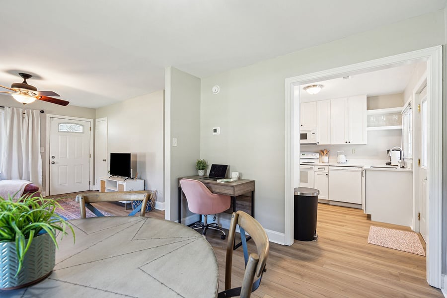 Adjacent to the kitchen is a dining area with a 4-person table and a dedicated workspace for remote work.