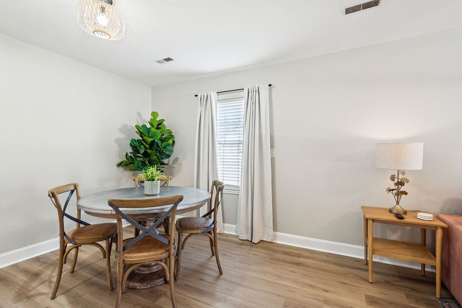 Adjacent to the kitchen is a dining area with a 4-person table and a dedicated workspace for remote work.