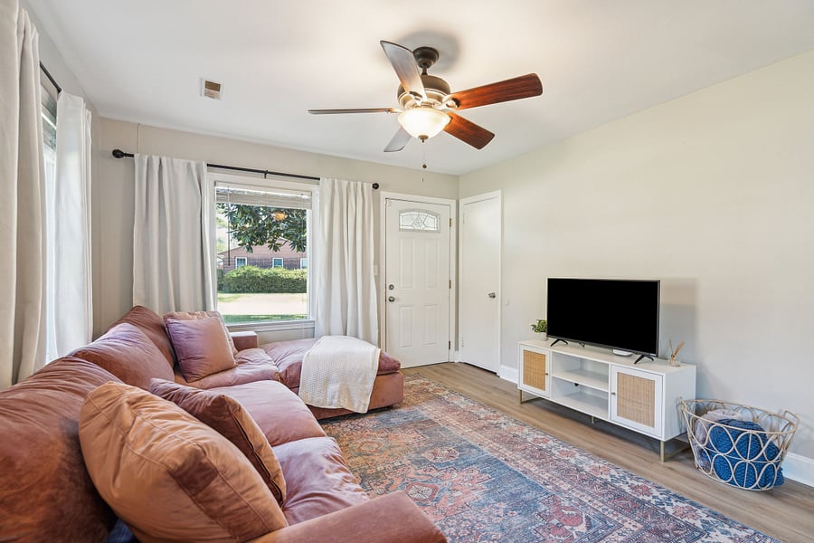 The spacious living room features a large, comfortable sectional and a smart TV, perfect for relaxing after a day of work or exploring the area.
