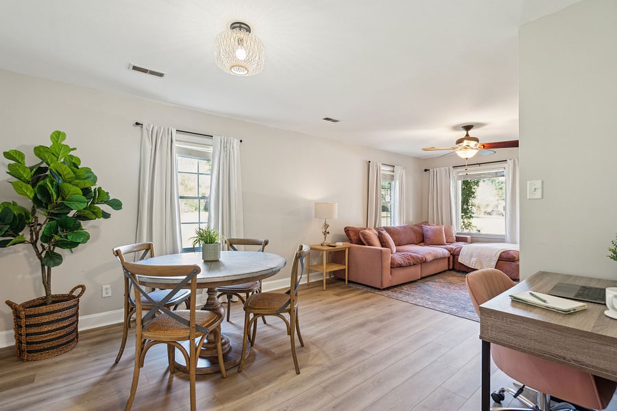 Adjacent to the kitchen is a dining area with a 4-person table and a dedicated workspace for remote work.