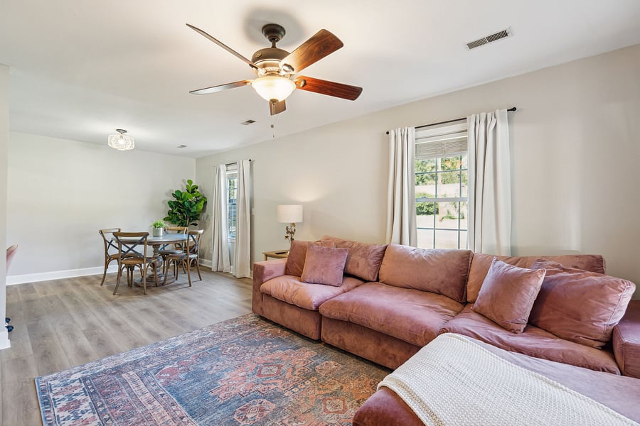 The spacious living room features a large, comfortable sectional and a smart TV, perfect for relaxing after a day of work or exploring the area.
