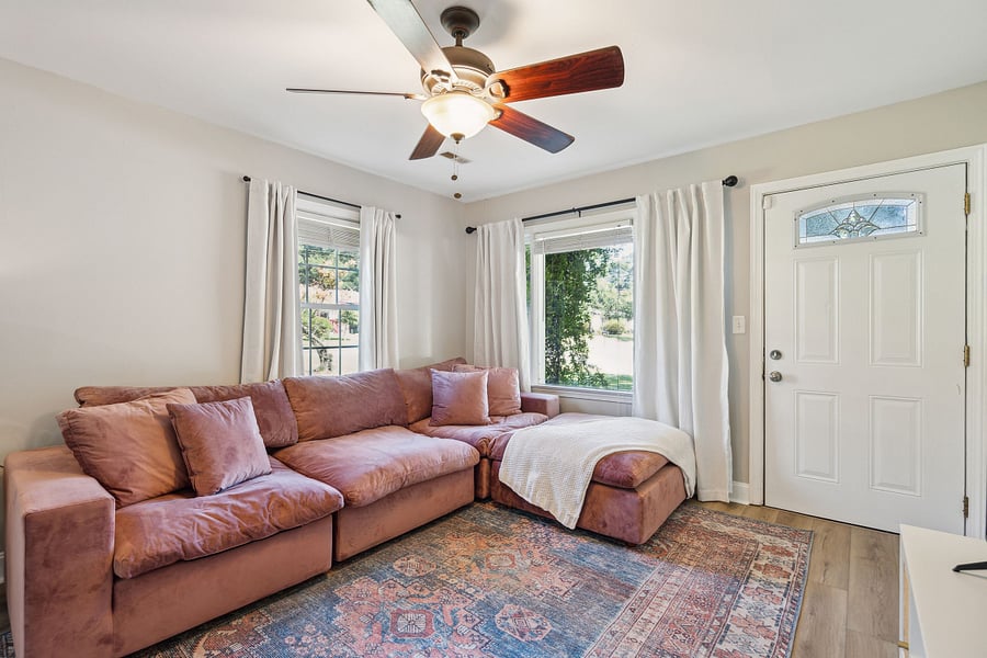 The spacious living room features a large, comfortable sectional and a smart TV, perfect for relaxing after a day of work or exploring the area.
