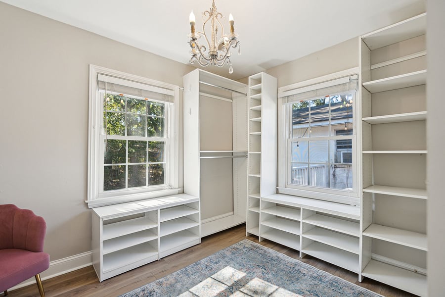 Additional clothing storage for both bedrooms can be found in the room next to bedroom #1. This small room has been converted into a large walk-in closet with built in racks and shelves.
