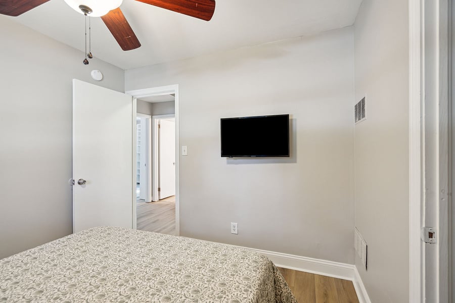 Bedroom #2 includes a queen bed, smart TV, and a small closet for clothing storage.
