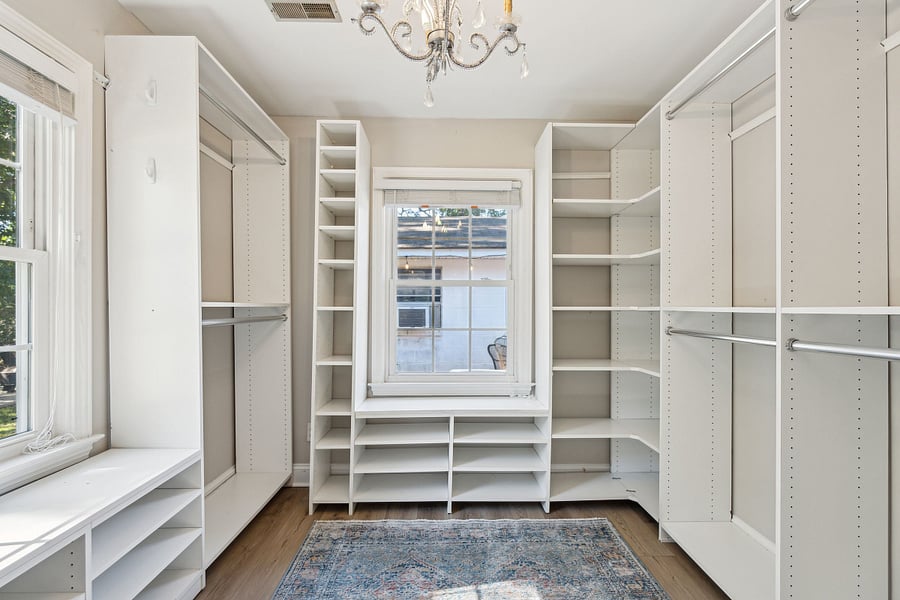 Additional clothing storage for both bedrooms can be found in the room next to bedroom #1. This small room has been converted into a large walk-in closet with built in racks and shelves.
