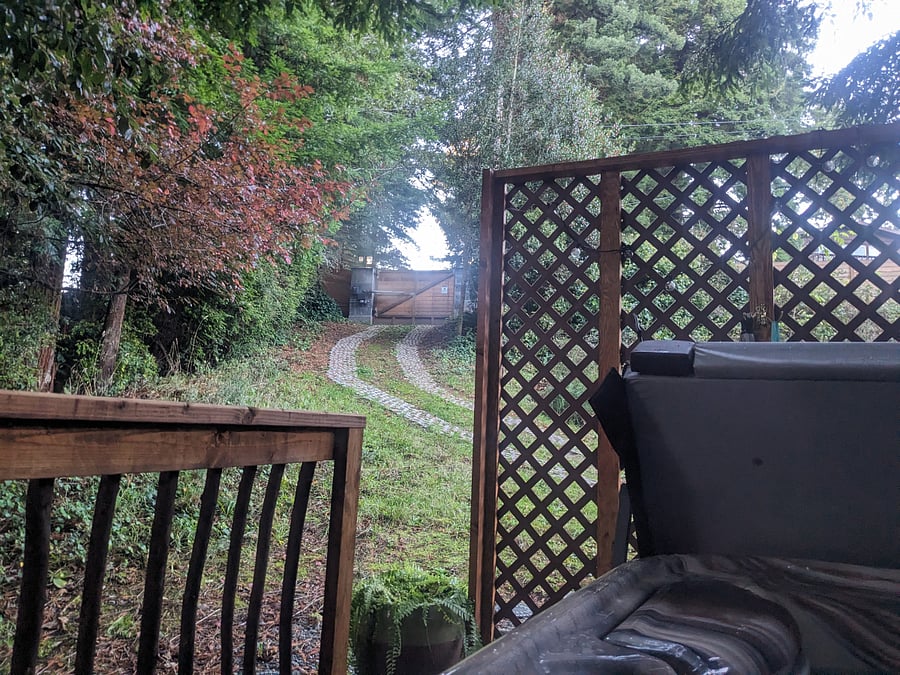 view of driveway from hot tub