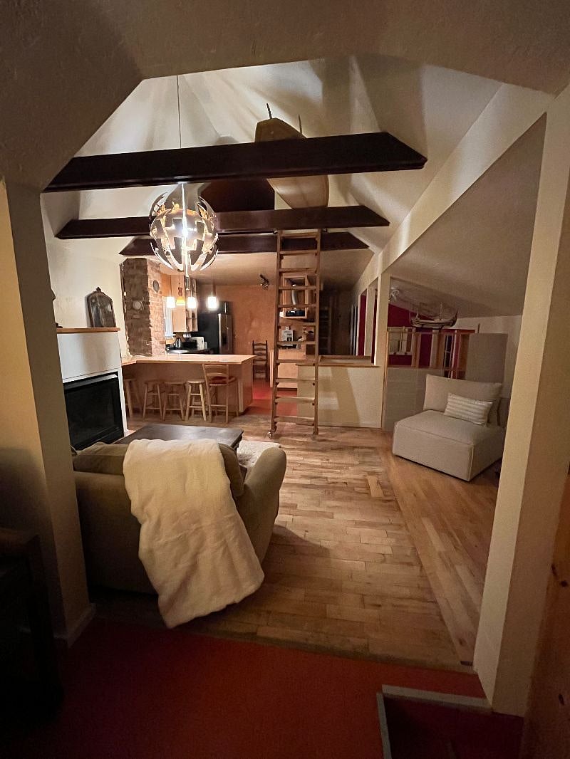 View from couch looking at kitchen. You can see the ladder to loft--please keep all people off. It's not safe at all.