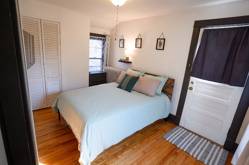 Separate bedroom from kitchen, leading to large deck outside