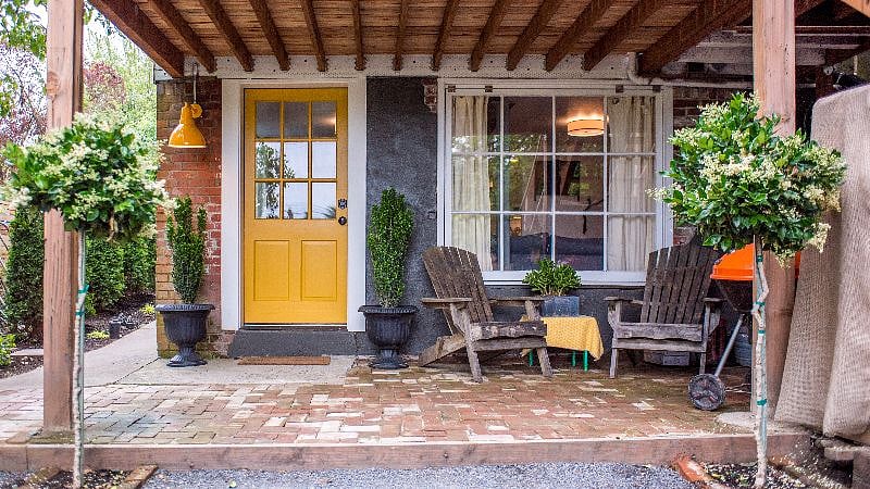 Cozy entry and patio overlooking gardens.