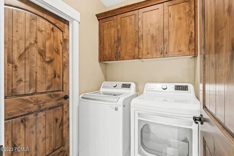 Separate laundry room with new washer and dryer